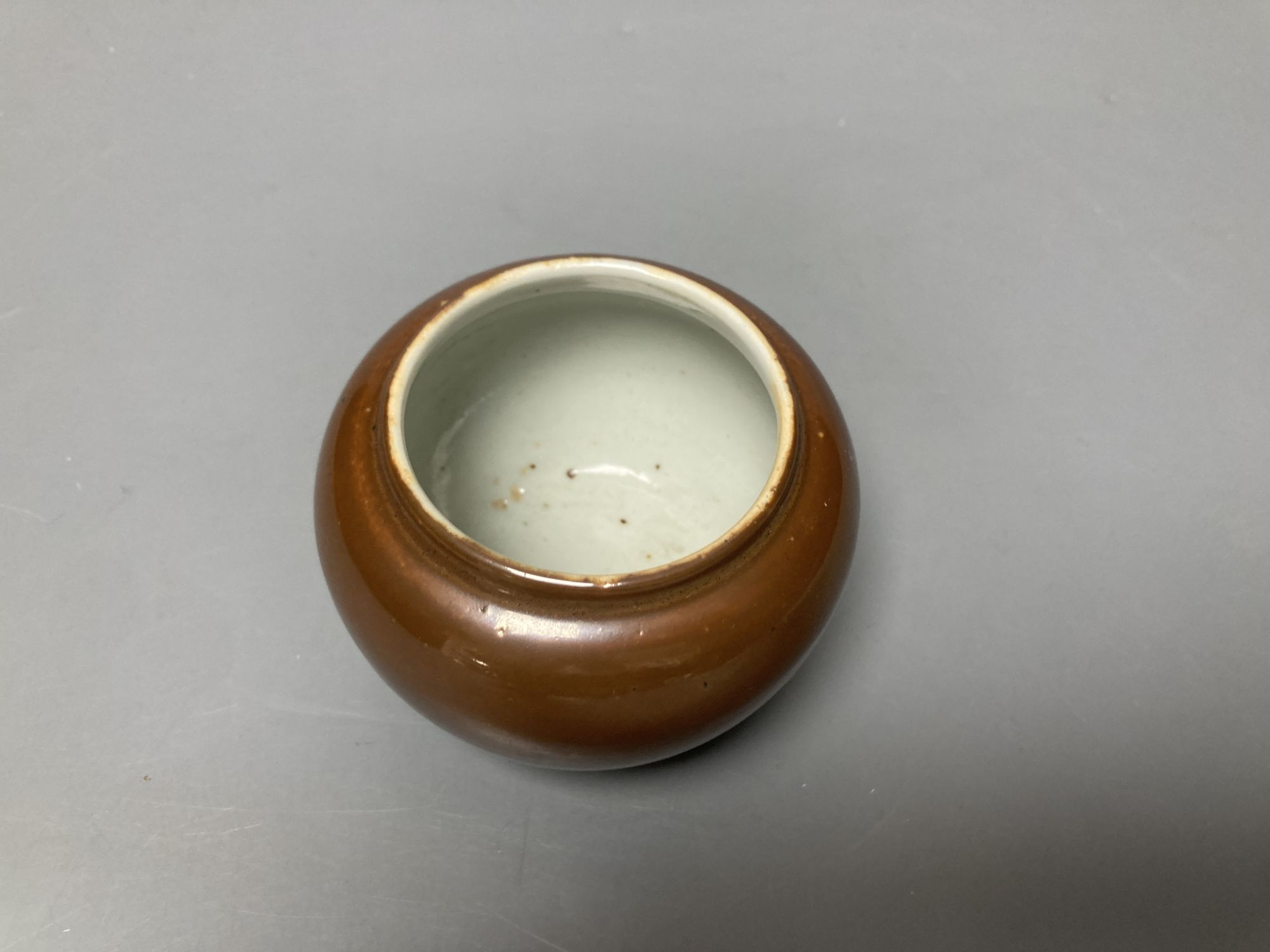 A Chinese cafe-au-lait glazed pot, Kangxi mark but later, height 7cm
